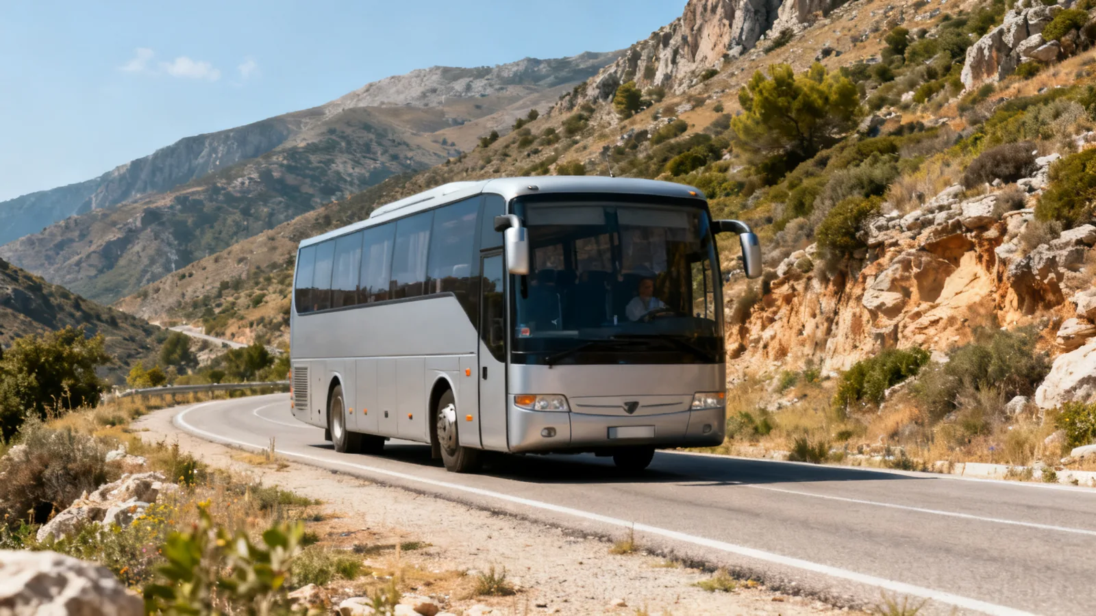 An unbranded coach on a mountain road