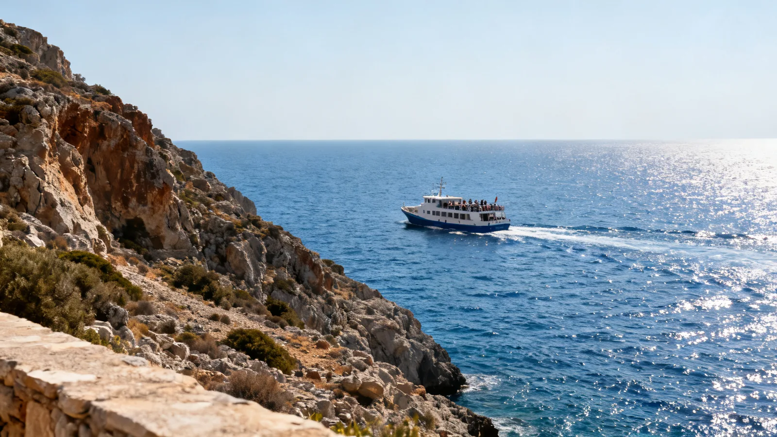 Small passenger ferry off the rugged southern coast of Crete